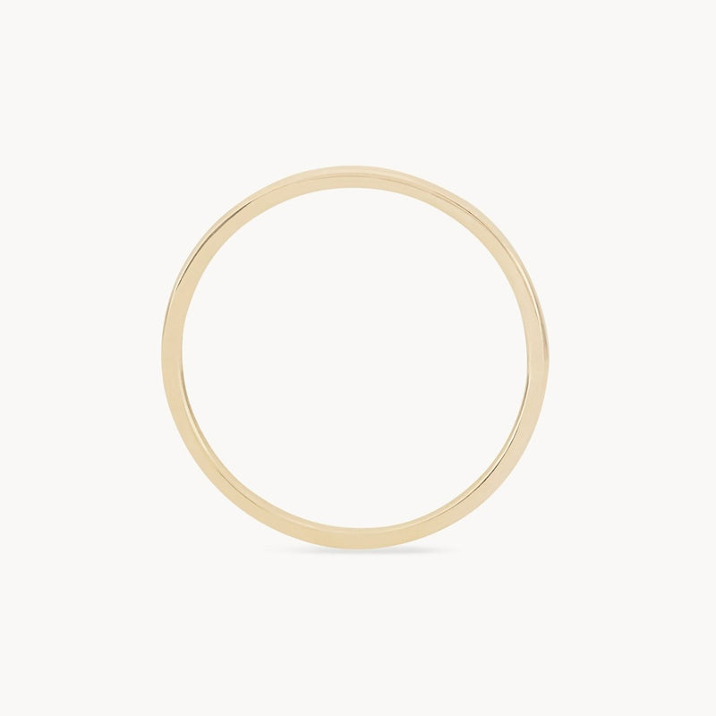 A thin, circular "plain jane stacking ring" made of 10k yellow gold from bluboho is displayed against a plain white background. The simple design features a smooth, polished finish without any additional adornments or detailing. The ring is elegant and minimalist in style.