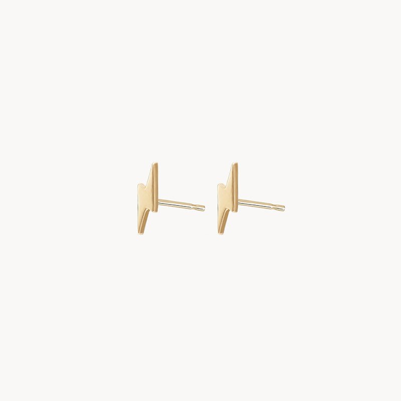 The Everyday Little Lightning Bolt Earrings from bluboho are crafted in 14k yellow gold. These minimalist stud earrings feature a sleek lightning bolt design with posts for fastening, making them a modern and stylish accessory choice.