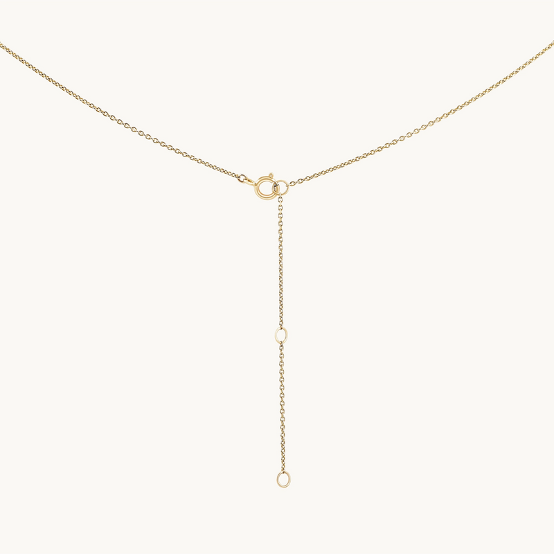 The classic cable chain - 10k yellow gold by bluboho features a fine chain with a circular clasp at the top center. From the clasp, a vertical chain extends downward, ending with a small circular link. The design is minimalistic and elegant.