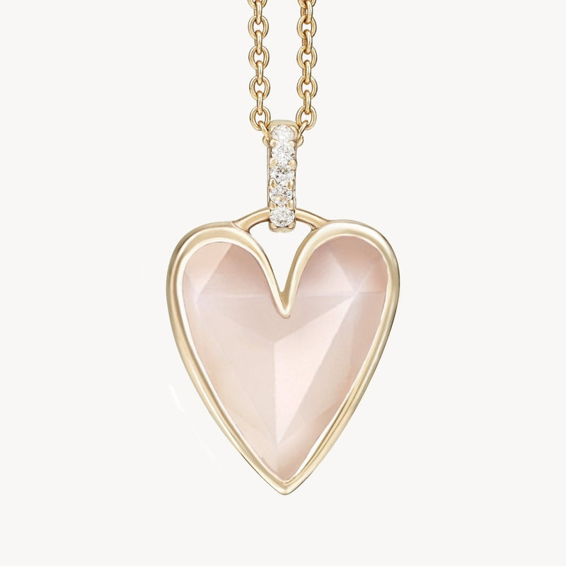 The bluboho pink opal diamond heart mood charm features a faceted pink opal gemstone set in a heart-shaped pendant. The loop of the pendant is adorned with small, sparkling diamonds and attached to an interlocking 10k yellow gold chain, embodying an elegant and delicate design.