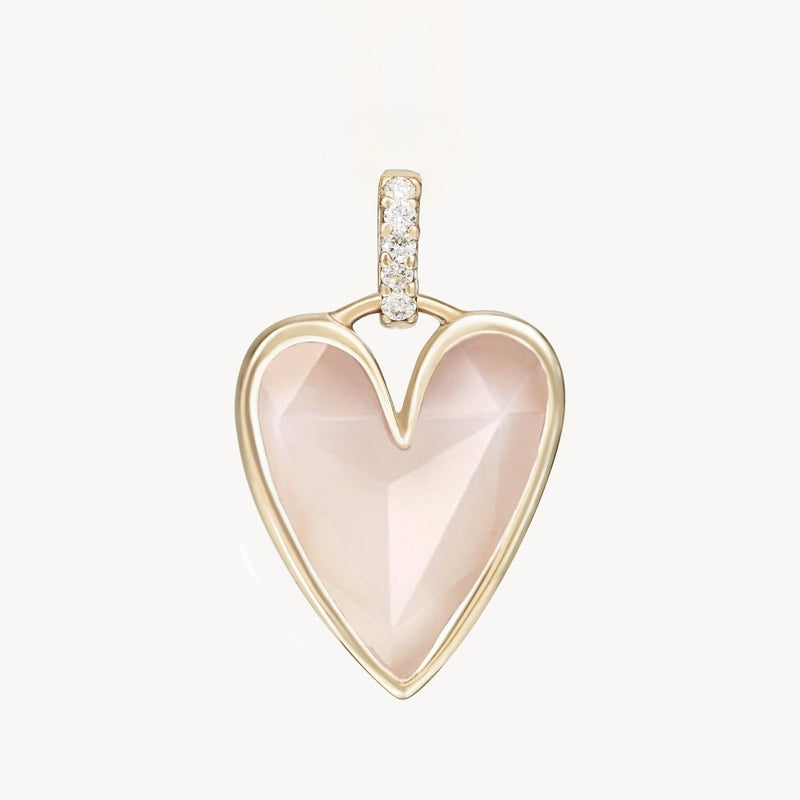 The *bluboho pink opal diamond heart mood charm* features a heart-shaped pendant with a light pink, faceted pink opal gemstone at its center, elegantly framed by a 10k yellow gold outline. The bail is embellished with small, sparkling diamonds, seamlessly connecting the pendant to the chain. The image showcases the charm against a plain white background.