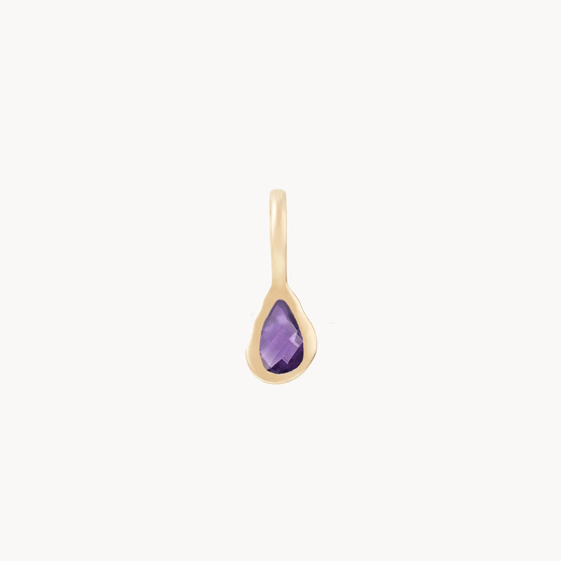 The pear amethyst February Mood Birthstone Charm from bluboho is a 10k yellow gold pendant featuring a faceted teardrop-shaped amethyst gemstone. The rich purple stone is securely set in a smooth gold frame and hangs from a simple gold loop. This minimalist yet elegant design accentuates the vivid hue of the amethyst beautifully.