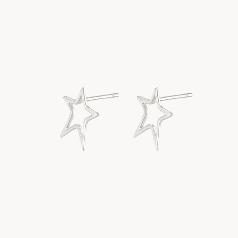 The bright star earrings by bluboho are crafted from sterling silver, featuring a minimalist design with an open star outline and a straight post for fastening. These trendy and elegant earrings offer a sleek look perfect for any occasion.