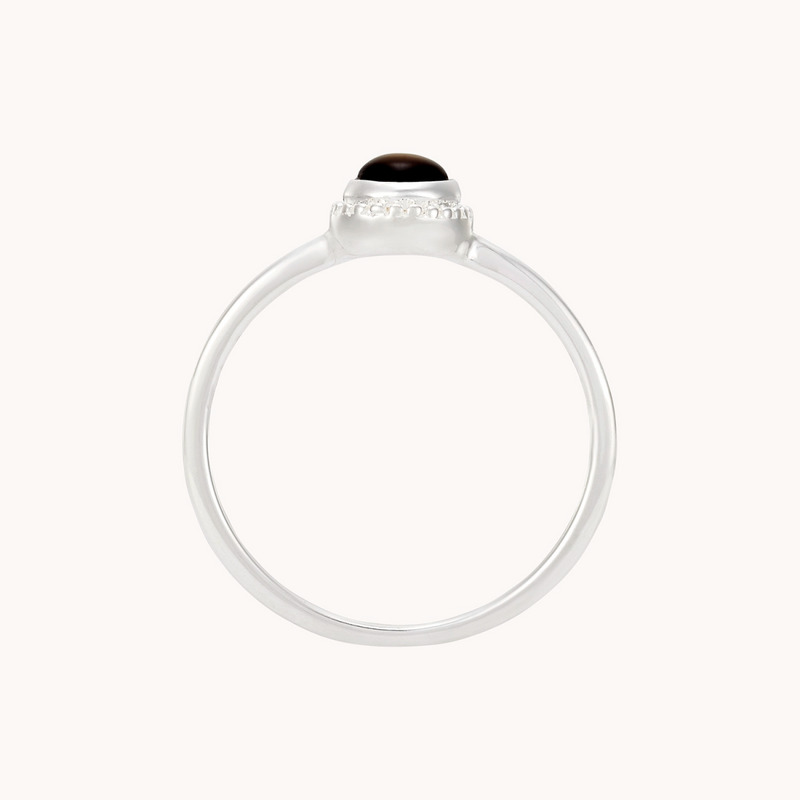 Introducing the Full Moon Dark Mother of Pearl Ring Silver by bluboho, featuring a sleek, silver band and a rounded black mother of pearl gemstone set in a simple bezel setting. The thin and smooth band complements the minimalistic and elegant design, while the glossy finish of the gemstone beautifully contrasts with the matte silver band.