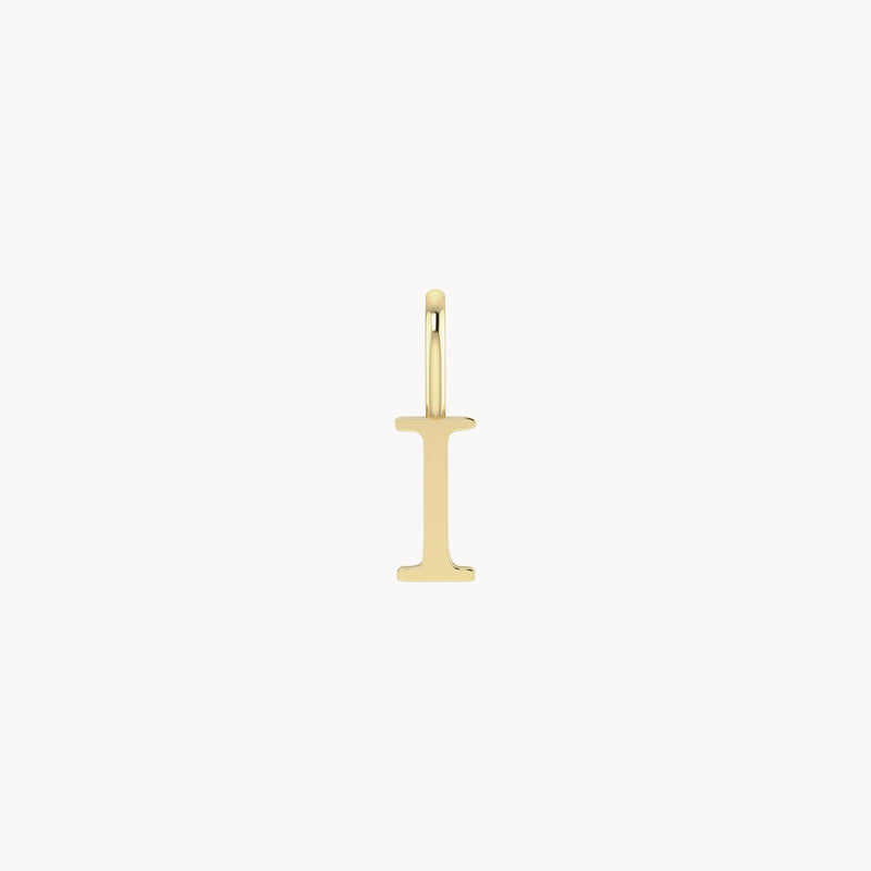 A bluboho letter charm - 10k yellow gold shaped like the letter "I." The charm has a simple and clean design with a small loop at the top for attaching to a chain. It is positioned vertically against a white background.