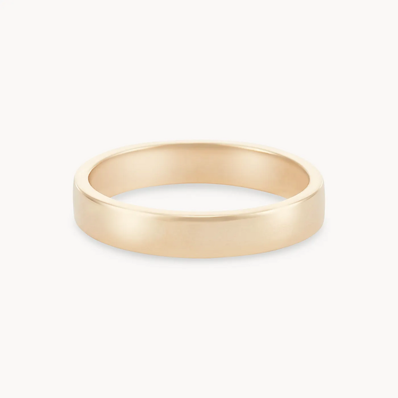 An infinity love band polished - 14k yellow gold from beloved by bluboho with a smooth, polished surface. The band is of medium width and has a simple, classic design with no engravings or embellishments. The ring is displayed against a white background.