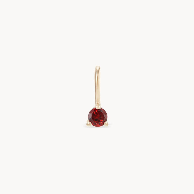 Introducing the Serendipity January Birthstone Charm by Bluboho, crafted in 10k yellow gold and featuring a single round garnet gemstone in a minimalist setting. The design is simple and elegant, perfectly showcasing the vibrant deep red hue of the garnet.