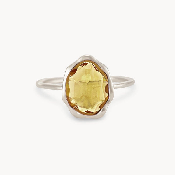 The bluboho citrine mood ring features an oval-shaped, faceted yellow citrine gemstone set in the center. The gemstone boasts an irregular, bezel setting, complemented by a smooth and simple sterling silver band. The product is displayed against a plain white background.