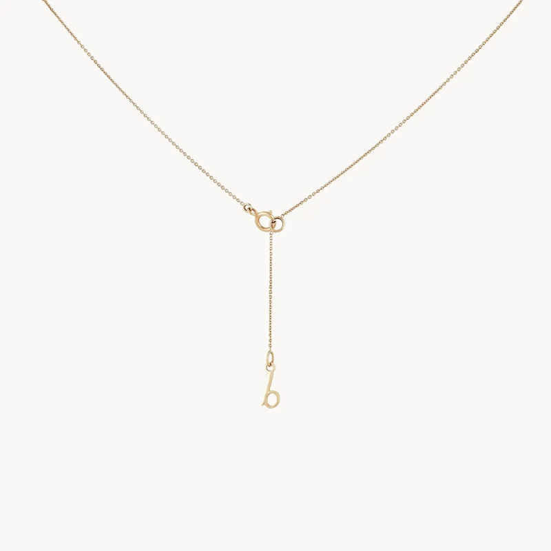 Moonlight crescent diamond necklace by bluboho: A delicate gold necklace featuring a fine chain and a small crescent moon charm adorned with diamonds, elegantly hanging from the center. The charm connects to the chain through two interlocking circular links, resulting in a minimalist and sophisticated look against a white background.