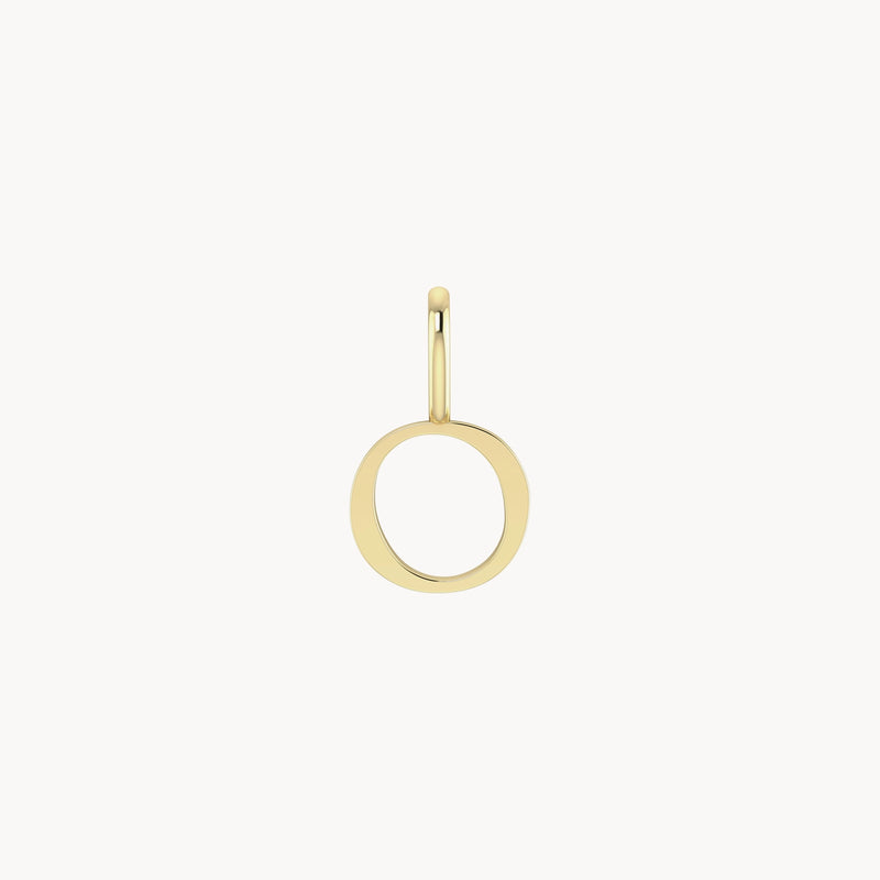 A single letter charm - 10k yellow gold by bluboho with a slightly irregular, circular shape against a white background. The charm has a smooth, shiny finish and a subtle clasp at the top.