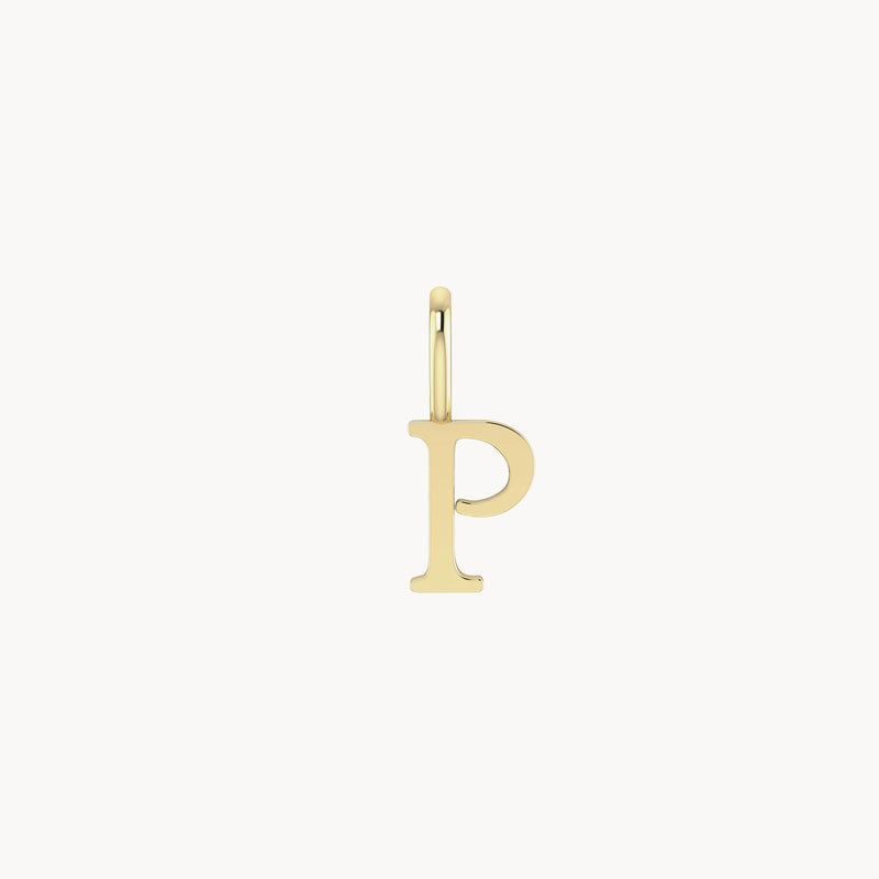 A delicate bluboho letter charm - 10k yellow gold in the shape of the letter "P", attached to a small gold loop for stringing onto a necklace or bracelet. The charm has a polished finish, reflecting light and giving it a shiny appearance.