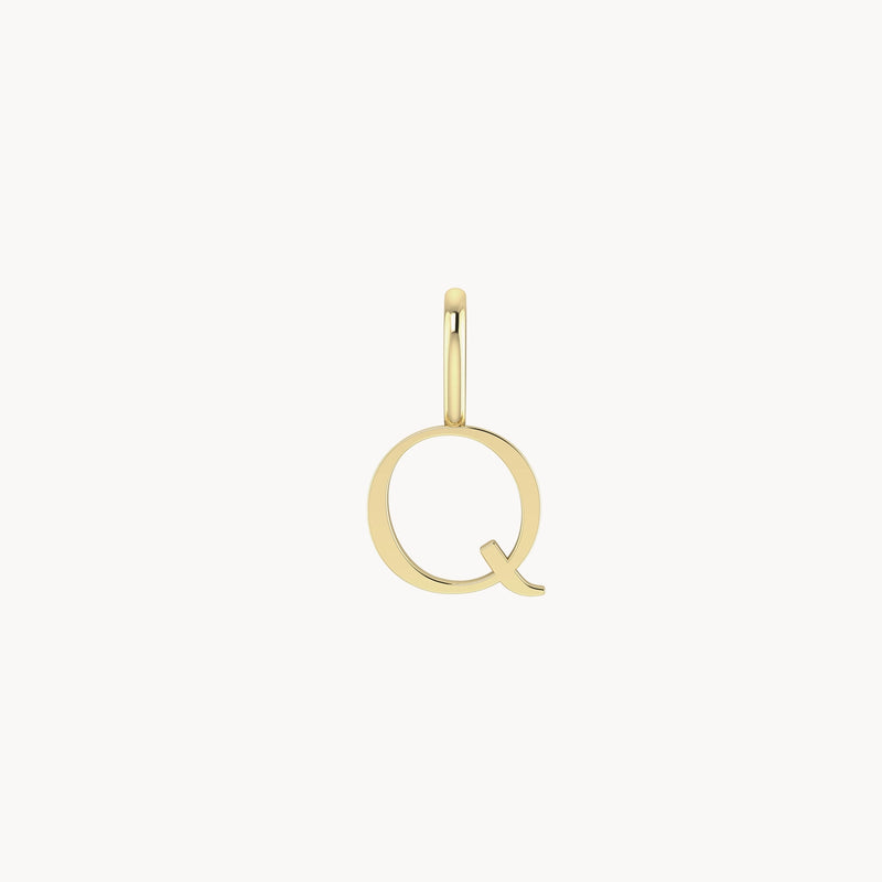 A simple gold pendant in the shape of the letter "Q" with a small loop at the top for attaching to a necklace or bracelet. The design is minimalistic and smooth, highlighting the elegant curves of the letter. The background is plain white. The product is called letter charm - 10k yellow gold, by bluboho.