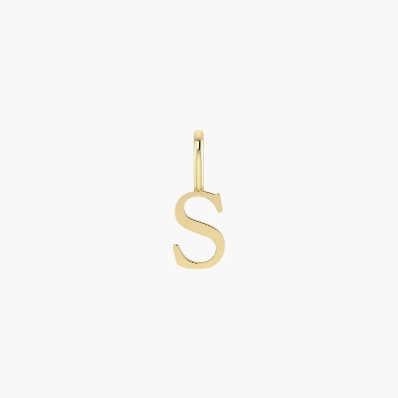 A letter charm - 10k yellow gold from bluboho in the shape of the letter "S" with a small loop at the top for attaching to a necklace or chain. The charm is simple and elegant, with a smooth, polished surface.