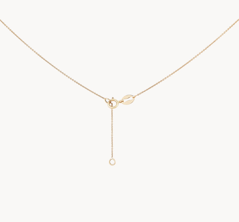 The abacus tripod necklace by bluboho is a delicate gold piece with a fine chain, showcasing a minimalist design. It features a small circular clasp and a drop chain that extends down, ending in another small circular loop. The overall design is simple and elegant.