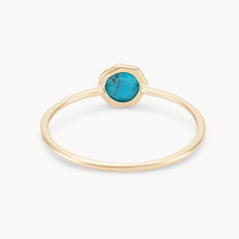 A delicate gold ring featuring a simple band and a round, vibrant turquoise gemstone set in a smooth bezel setting. The minimalist design focuses on the vivid blue stone, offering a chic and elegant look. Introducing the turquoise mini mood ring - 10k yellow gold, turquoise by bluboho.