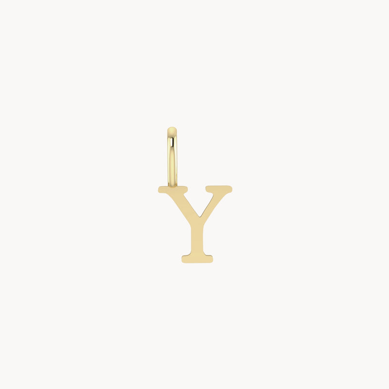 A letter charm - 10k yellow gold by bluboho featuring a charm shaped as the uppercase letter "Y." The charm hangs from a small gold hoop. The background is plain white.