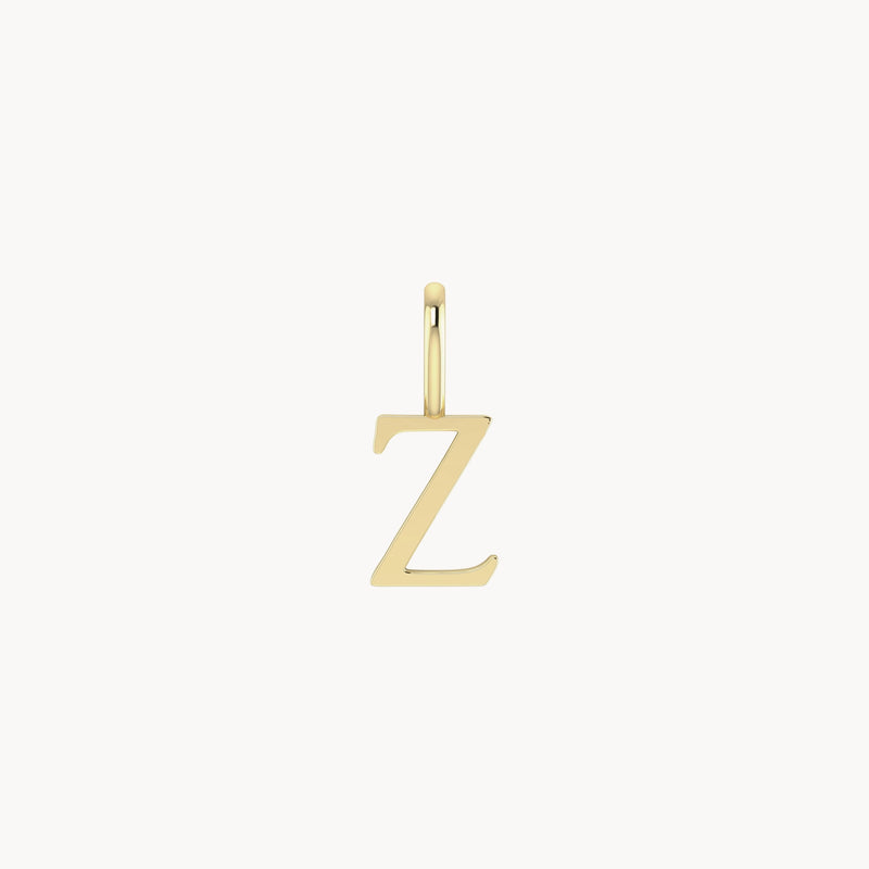 A bluboho letter charm - 10k yellow gold in the shape of the letter "Z" with a small loop at the top for attaching to a necklace or bracelet, set against a white background. The pendant has a sleek, polished finish.