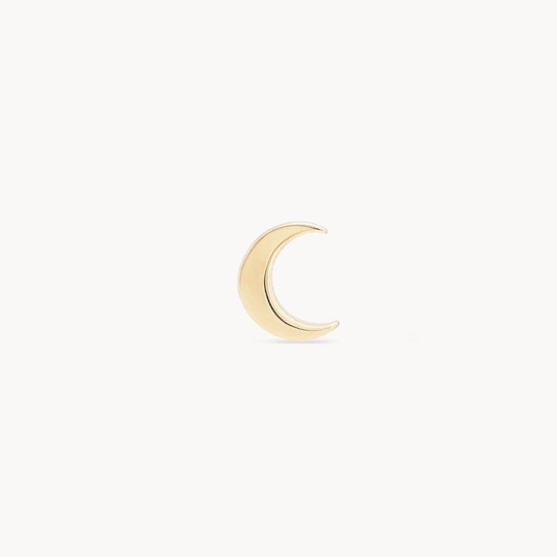 An Everyday larger crescent moon earring from bluboho, crafted in 14k yellow gold, is displayed against a plain white background. The earring features a smooth and polished surface.