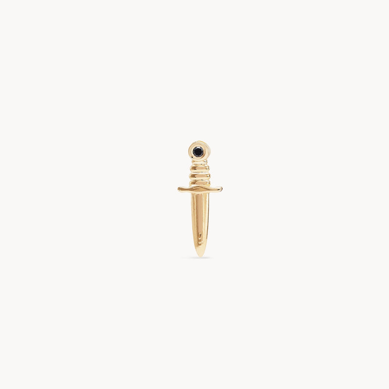 A small, gold earring shaped like a dagger with a thin blade and a black diamond set in the hilt. The "Dagger earring - 14k yellow gold, black diamond" by bluboho features a simplistic and elegant design with smooth edges, suitable for use as jewelry, such as an earring or necklace pendant. The piece is displayed against a white background.