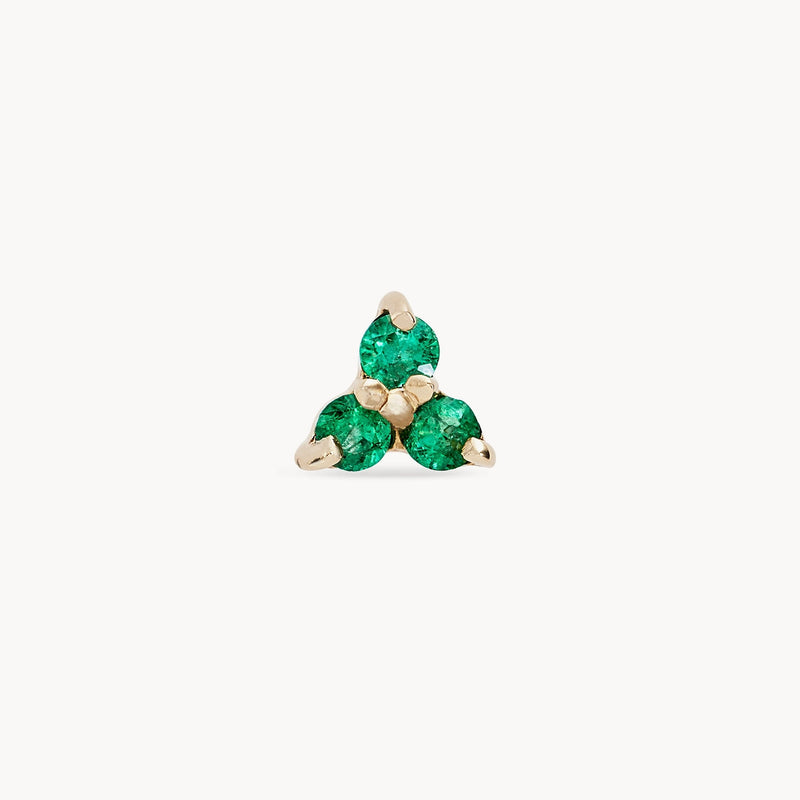 The abacus tripod emerald earring by bluboho, crafted from 14k yellow gold, features a minimalist and elegant design with three small, round emeralds set at each point of the triangle. The vibrant green gemstones add a touch of color to the sophisticated earring against a white background.