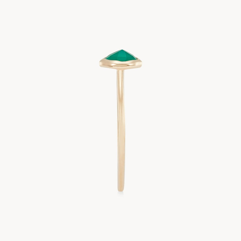 The green chalcedony mini mood ring from bluboho showcases a green triangular gemstone set in a minimalist 10k yellow gold band. The smooth and slender design accentuates the ring's simplicity. Featuring a single prong mount, this piece exudes elegance and modernity.