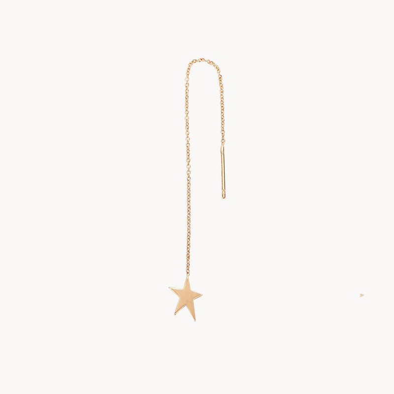 The "Guidance star threader - 14k yellow gold" by bluboho is a minimalist and elegant earring featuring a delicate thin chain with a small star charm at one end and a straight bar for threading through the ear piercing at the other.