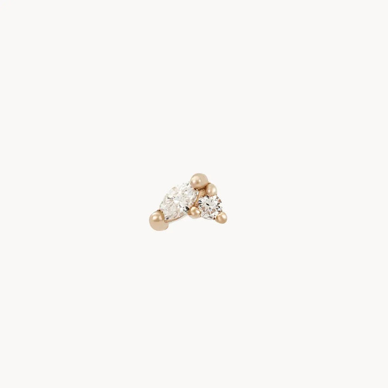 Introducing the Lean on me diamond stud - 14k yellow gold by bluboho: a delicate earring embellishing two small, differently shaped diamonds securely set with gold prongs. This elegant and minimalist piece is perfect for subtle yet sophisticated adornment, presented against a plain white background.