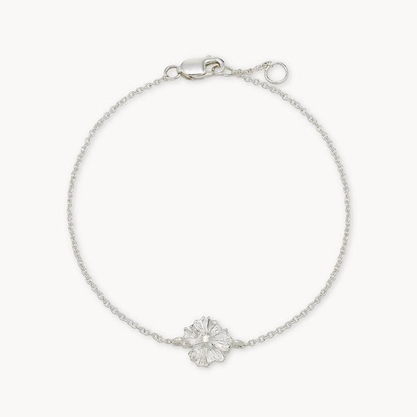 The little wildflower bracelet - sterling silver by bluboho is a delicate piece featuring a single, intricately detailed, flower-shaped charm at its center. The bracelet includes a simple chain and a secure clasp closure.