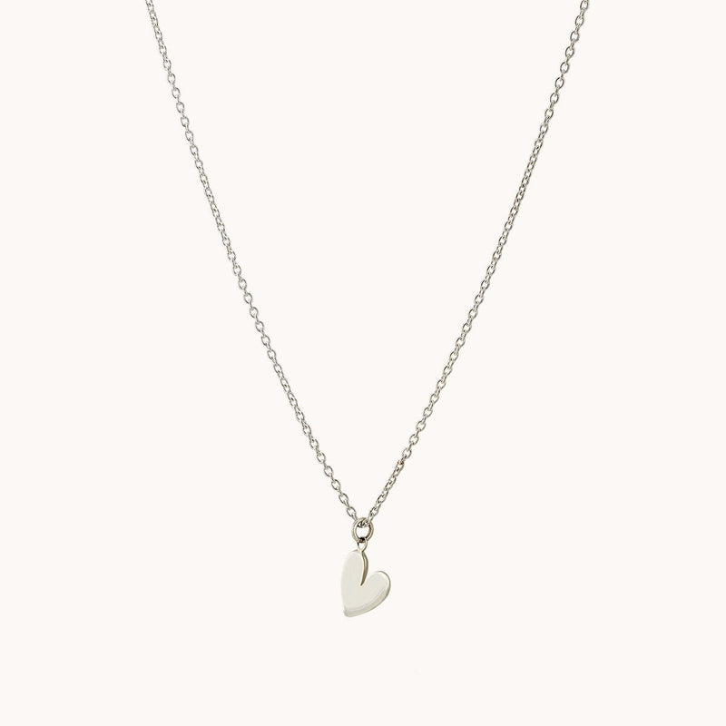 A delicate lovely necklace silver - sterling silver from bluboho featuring a fine chain with a small, simple heart-shaped pendant at the center. The background is plain and light-colored, highlighting the elegance and minimalistic design of this lovely necklace.