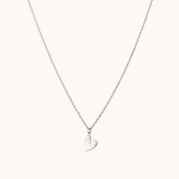 Introducing the "lovely necklace silver - sterling silver" by bluboho: a delicate chain necklace adorned with a small, polished heart-shaped pendant. The thin, minimalistic design of the chain highlights the simplicity and elegance of the heart charm against a plain white background.