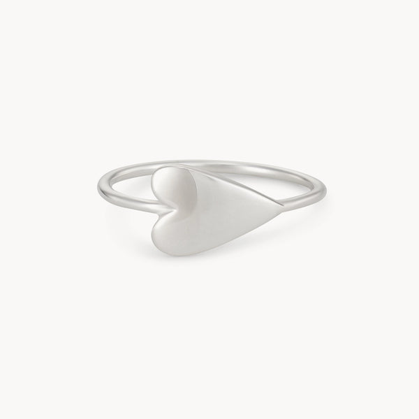 Introducing the "Lovely Heart Sideways Ring Silver" by bluboho, a delicate silver ring showcasing a minimalist, heart-shaped design tilted sideways at the front. The smooth and slightly rounded heart adds a modern and elegant touch, while the thin band complements the simplicity of the piece.