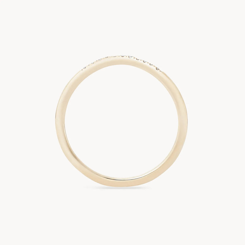 A wave eternity ring from Beloved by Bluboho, crafted in 14k yellow gold and featuring a white diamond, is showcased against a plain white background. The ring has a thin, circular band with no additional decorations or engravings visible in the image.