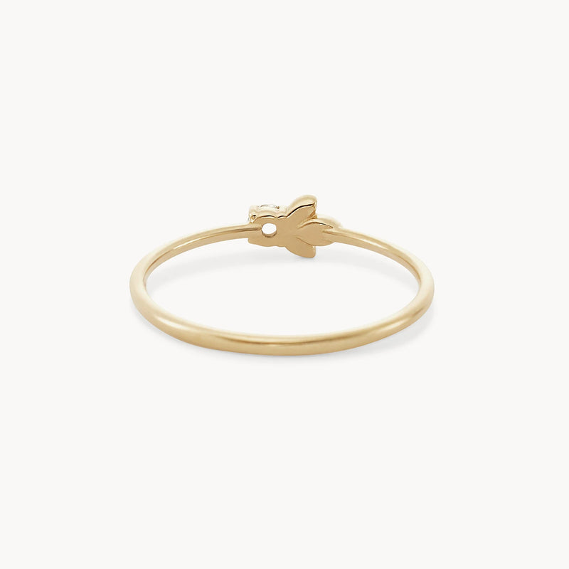 The Honey Bee Ring by bluboho is made from 14k yellow gold and features a minimalist design with a thin band and a small, leaf-shaped white diamond embellishment. It offers a subtle and elegant look, perfect for everyday wear or special occasions.