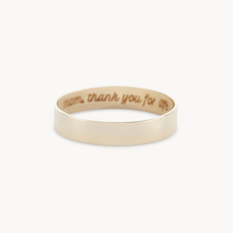 A delicate, 10k yellow gold Legacy Ring from bluboho, featuring an engraving on the inside that reads, "Mom, thank you for life." Displayed against a white background.