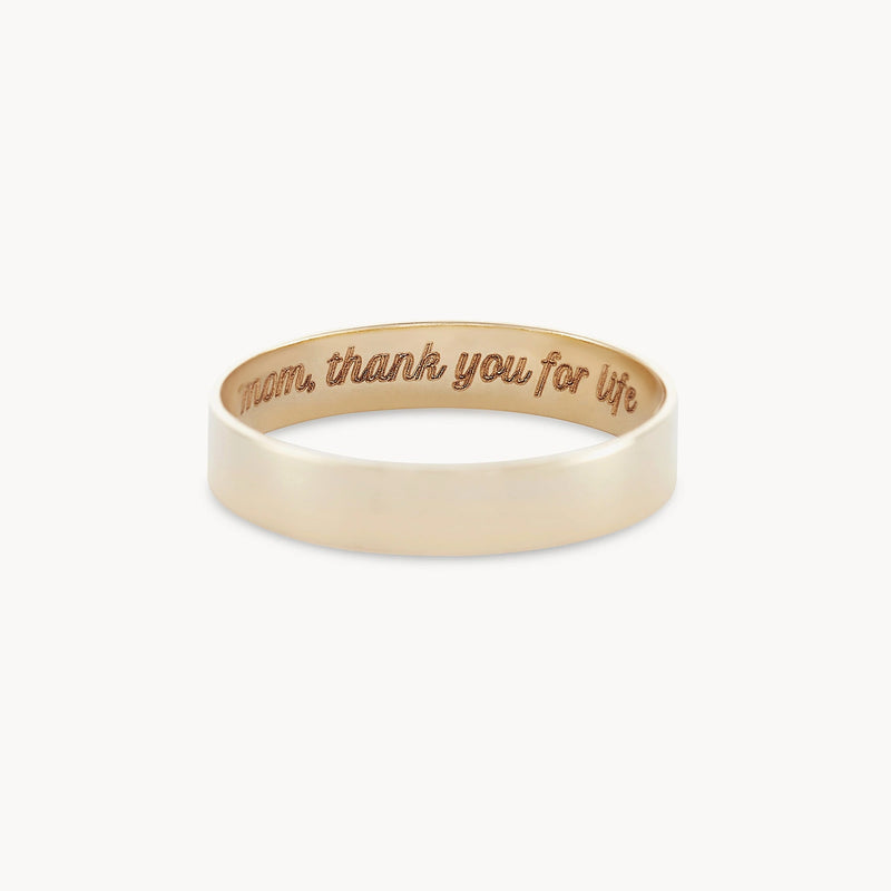 A legacy ring by bluboho, crafted from 10k yellow gold and featuring a smooth exterior surface. The inner band is engraved with the inscription, "mom, thank you for life.