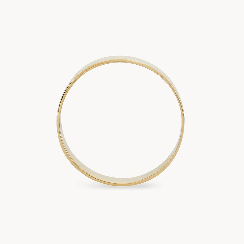 A simple, elegant legacy ring made of 10k yellow gold from bluboho with a smooth and shiny finish is shown against a plain white background. The ring is thin and classic in design, showcasing its circular shape and minimalistic style. This engravable piece epitomizes timeless beauty.