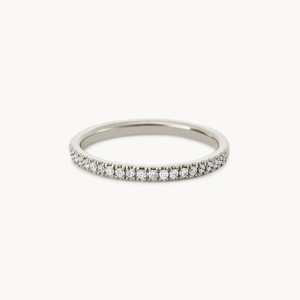 A delicate Endalaus II ring in 14k white gold adorned with a row of small, round-cut white diamonds set along the top half, creating a sparkling band, brought to you by beloved by bluboho.