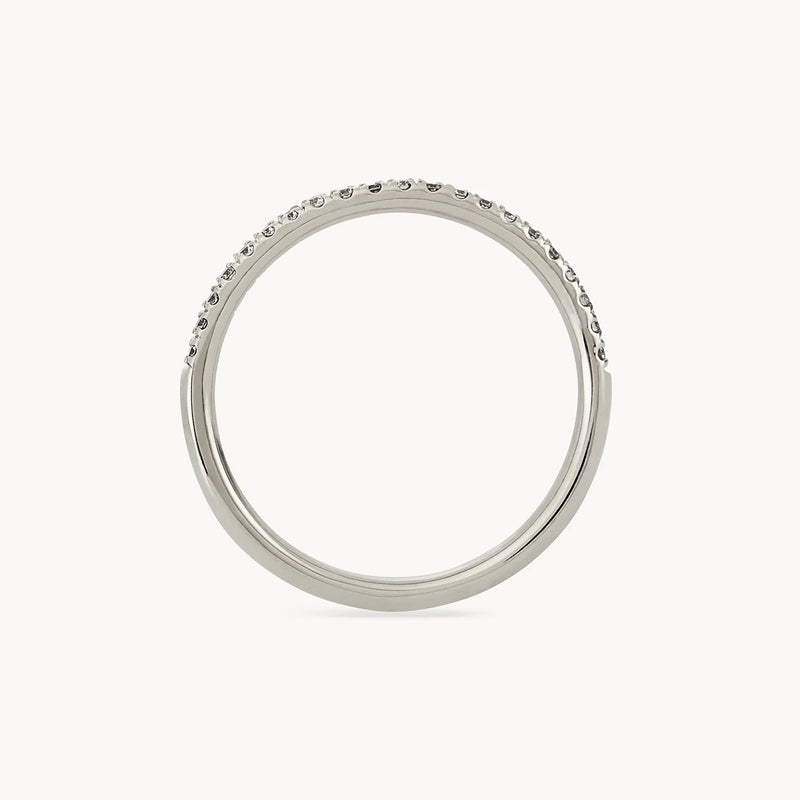 Introducing the Endalaus II ring by beloved by bluboho, this simple and elegant ring is crafted from 14k white gold. It features small, closely spaced round diamonds set along half of the band, while the smooth and unadorned remaining half highlights its simplicity and beauty.