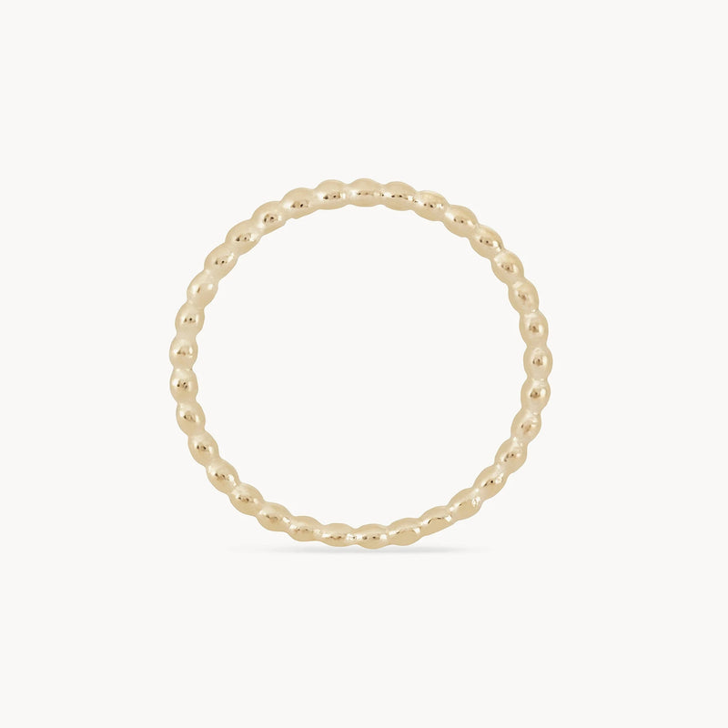 A delicate abacus ring - 10k yellow gold with a beaded design, featuring small, rounded beads connected in a continuous circle by bluboho. The ring is set against a plain white background.