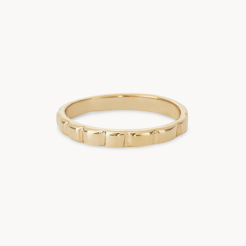 A bluboho peaks and valleys ring - 10k yellow gold with a smooth, polished surface and subtle, evenly spaced grooves around its circumference, is displayed on a plain white background. The ring has a simple, elegant design and appears delicate and lightweight.