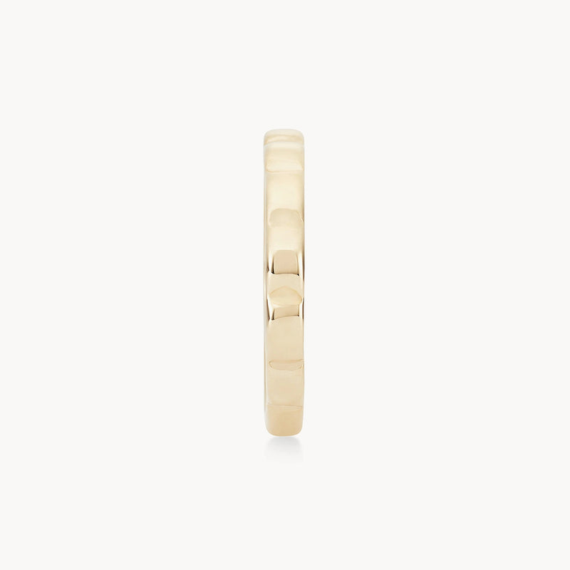 A close-up image of a bluboho peaks and valleys ring - 10k yellow gold viewed from the side. The image showcases the ring’s smooth, polished surface and rounded edges. The simplicity and elegance of the design are highlighted against a plain white background.