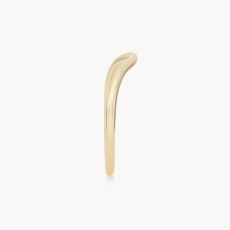 A minimalist plain wave band - 14k yellow gold by beloved by bluboho is displayed against a plain white background. The ring features a subtle, elegant bend along its band in a smooth, single, curved design.