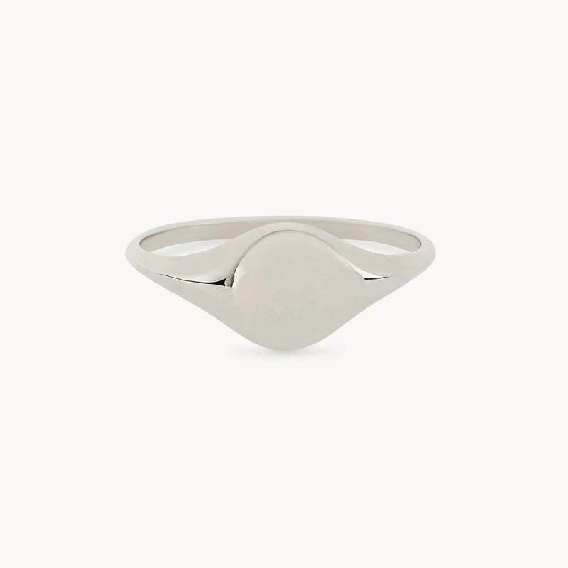 This is the Loyalty signet ring by bluboho, an elegant sterling silver piece with a smooth, polished surface. Its circular face is left blank, perfect for engraving, and the narrow band curves gently to meet the face against a plain white background.