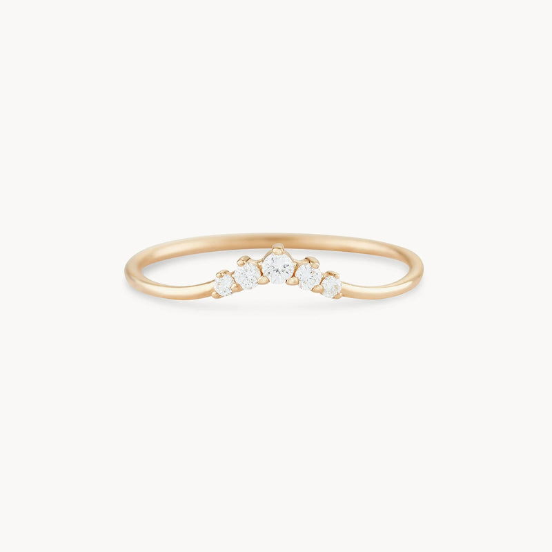 The Kismet serendipity ring from bluboho is made of 14k yellow gold and showcases five small white diamonds arranged in a subtle V-shape pattern on the top. The thin, elegant band highlights the simplicity and sparkle of the diamonds against a plain white background.