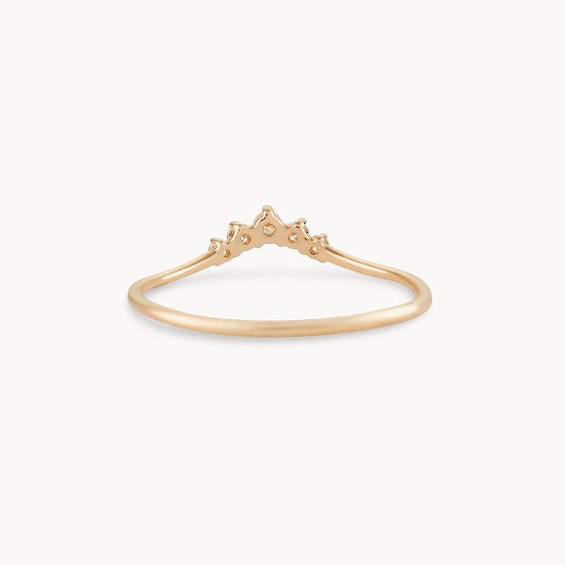 Introducing the Kismet Serendipity Ring by bluboho: a delicate 14k yellow gold ring with a minimalist, tiara-shaped design. Adorned with small geometric cutouts and a single, central white diamond-like stone, the elegant piece is set on a thin, polished gold band.