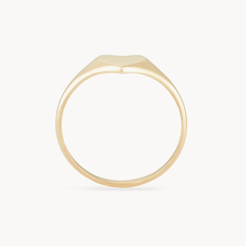 The Lovely heart signet ring by bluboho, crafted from 14k yellow gold, features a minimalist design with a smooth, slightly rounded top surface. The thin band is uniformly polished, creating a sleek and elegant appearance against a plain white background.