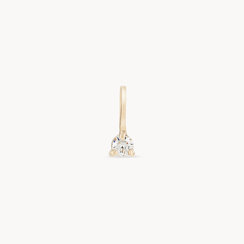 This serendipity April birthstone charm by bluboho is a single 10k yellow gold charm with a hook. It boasts a round-cut diamond set at its center, showcasing a sleek and minimalistic design. The plain white background accentuates the elegance and simplicity of this timeless piece.