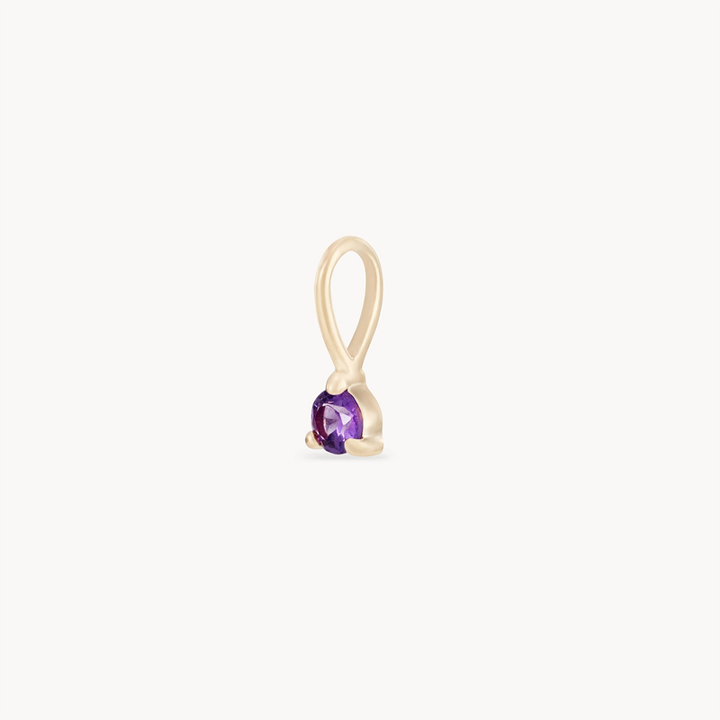 The serendipity February birthstone charm from bluboho, crafted in 10k yellow gold, showcases a minimalist and elegant design with a single loop at the top and a securely set small, round amethyst gemstone at the bottom.