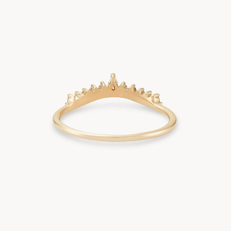 The Sunbeam Ring by Beloved by Bluboho is a delicate 14k yellow gold ring adorned with tiny, intricately detailed spikes forming a subtle chevron pattern. These gentle embellishments create a unique and elegant look against a plain white background, making it a truly captivating piece.