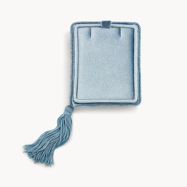 Introducing the velvet tassel box by bluboho: a light blue, rectangular jewelry box adorned with a decorative fringed tassel on one side. The lid is open, revealing a padded interior thoughtfully designed to hold rings or small treasures. Shot against a plain white background for clarity and elegance.